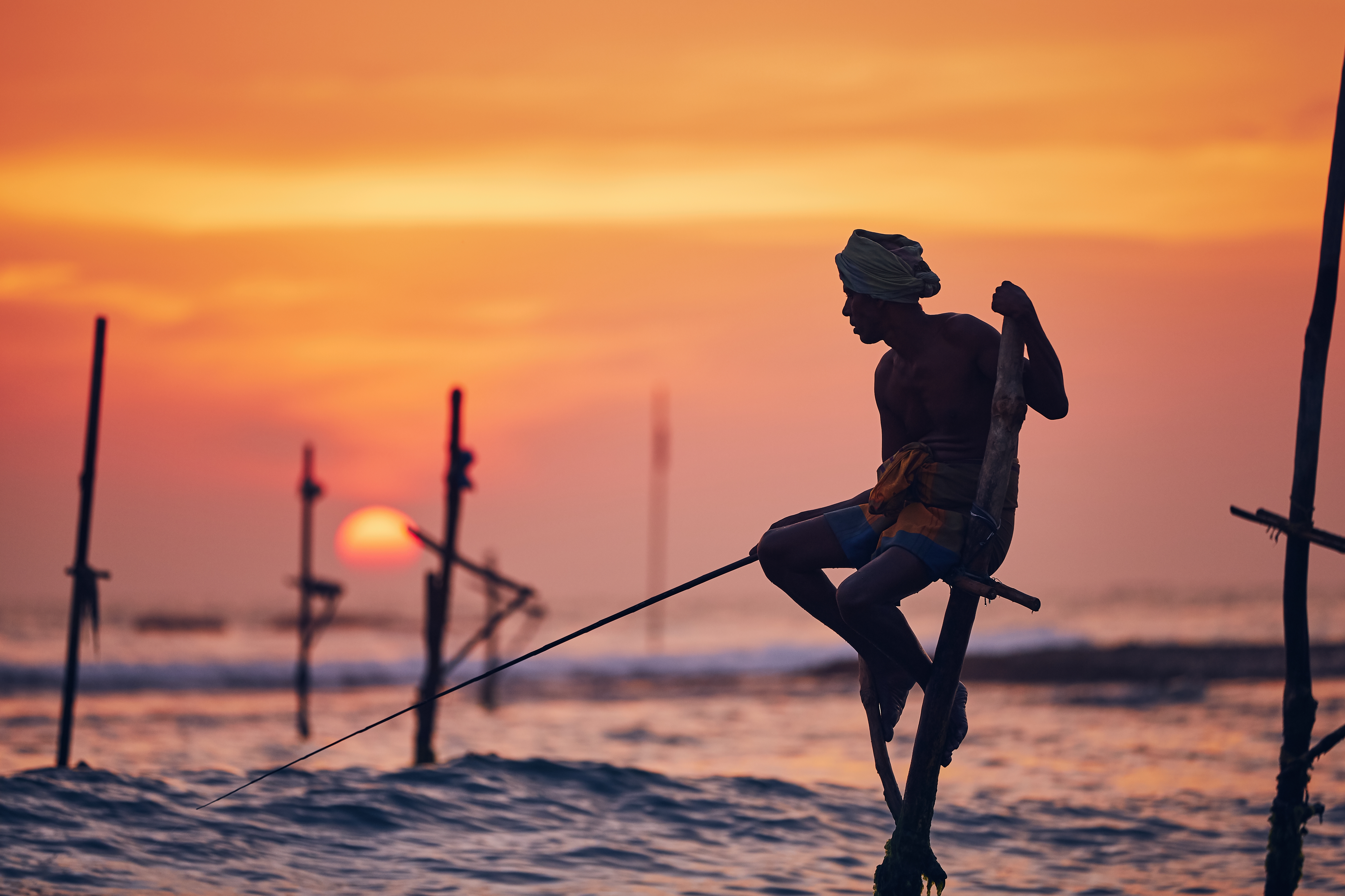 Silhouette of the traditional fisherman. Traditional stilt fishing near Galle in Sri Lanka.
